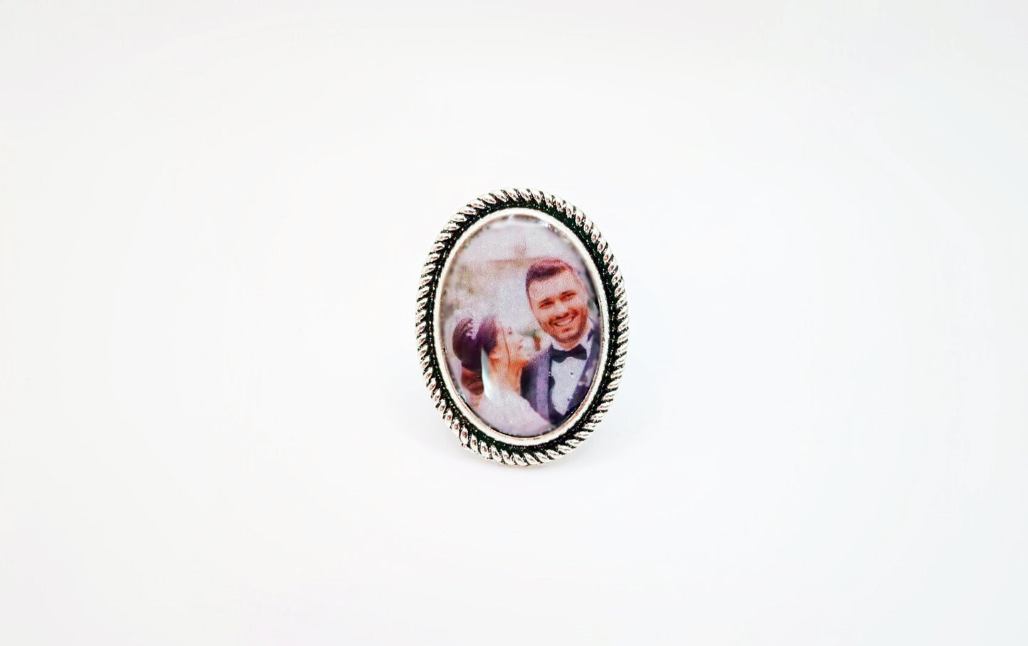 Large custom photo oval ring with decorative edge sealed in clear acrylic.